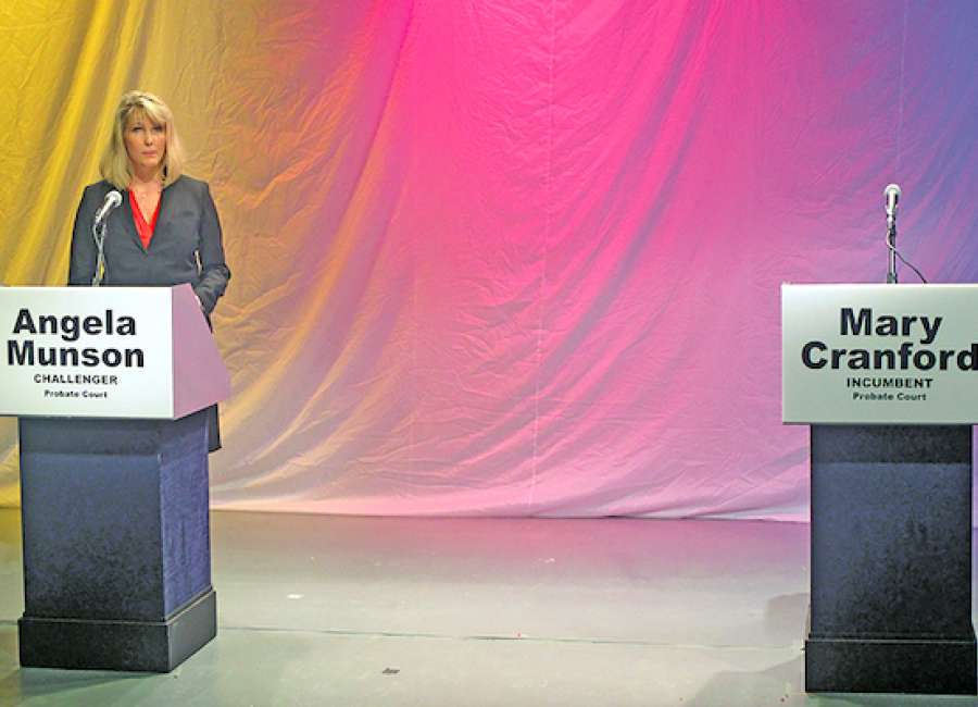 Munson alone on stage at probate forum