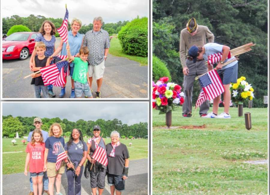 Volunteers place flags on graves of fallen